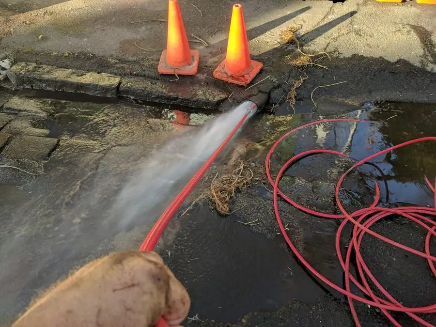 High-pressure hose clearing an emergency stormwater blockage